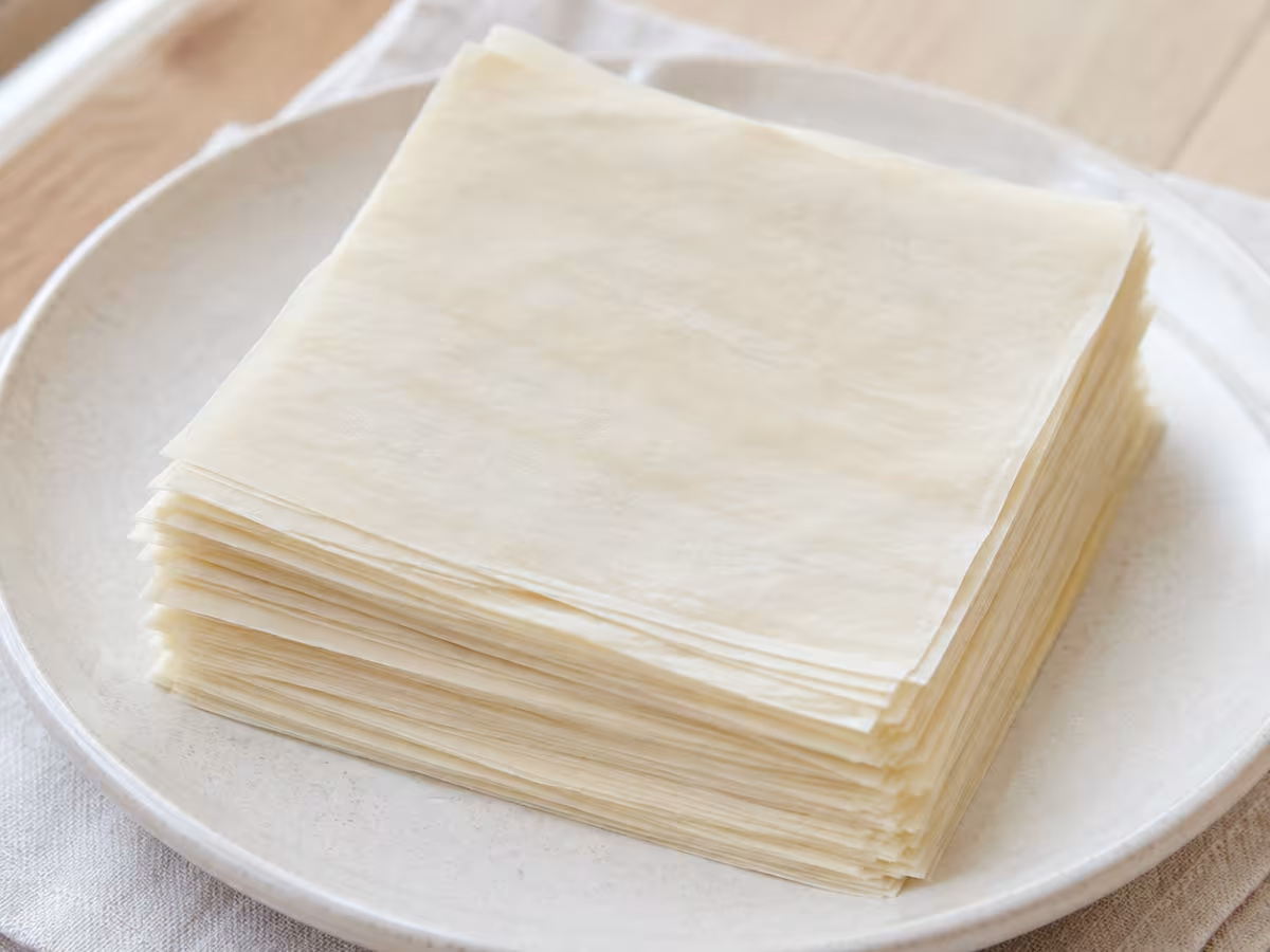 Thin square wheat pastry sheets, flexible when raw and crisp after cooking.