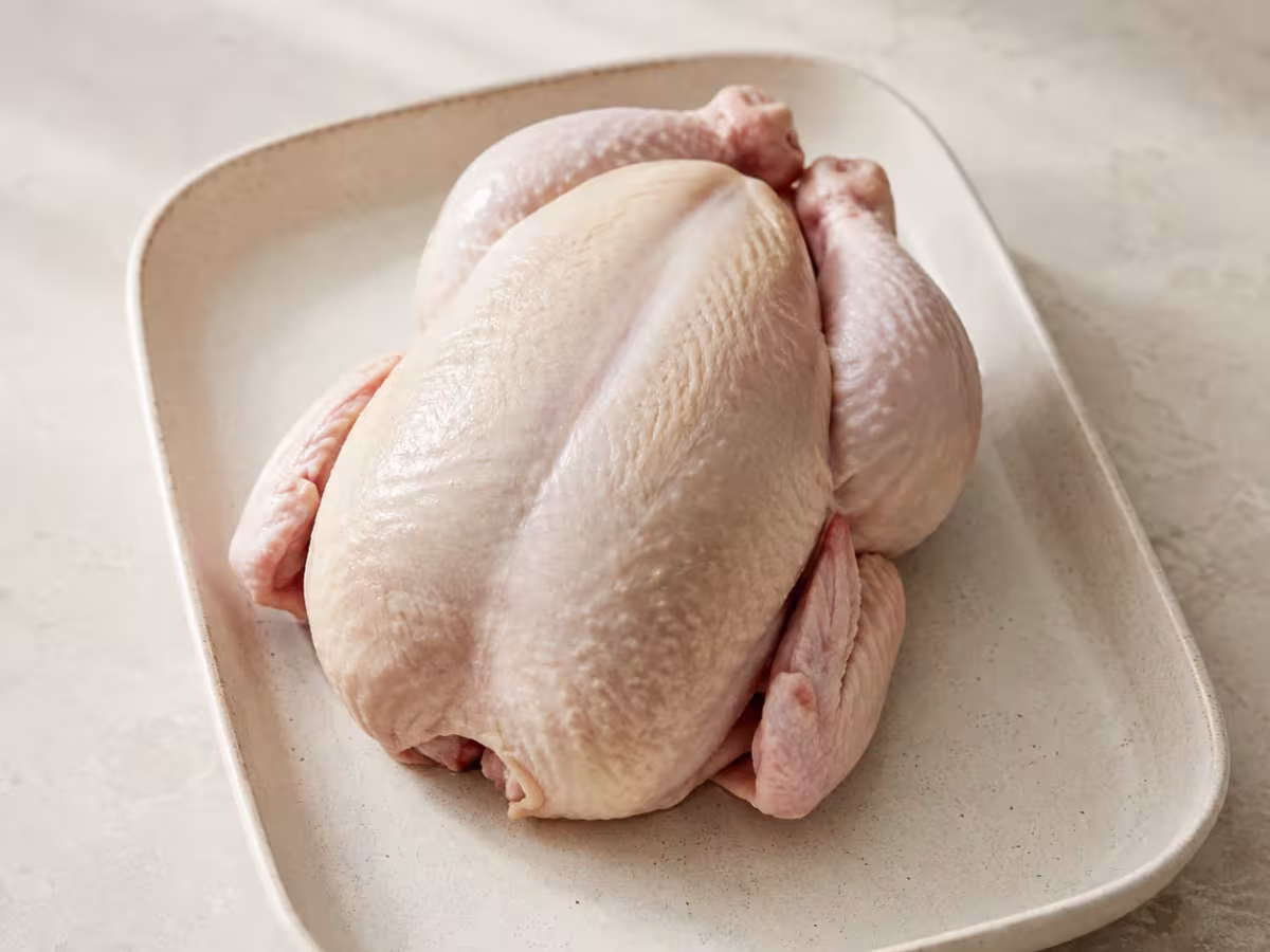 Fresh whole chicken, ideal for roasting until juicy with crisp skin.