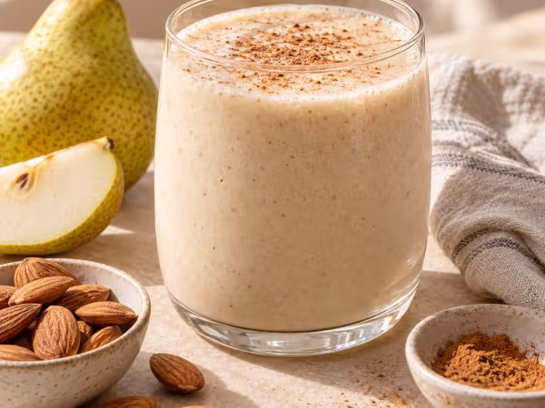 Pear almond drink and cinnamon smoothie in simple tableware