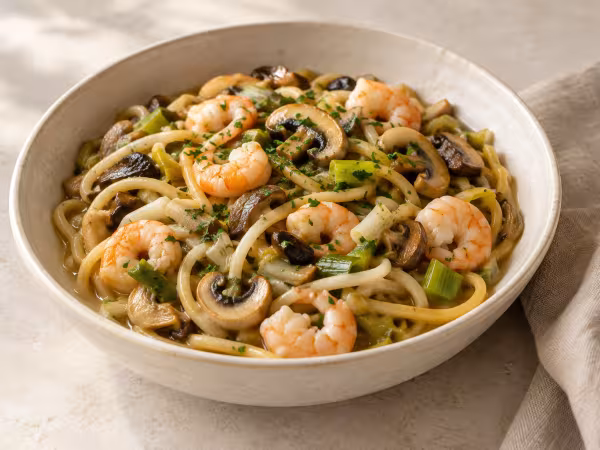 Noodles with prawns mushrooms and spring garlic ready to serve