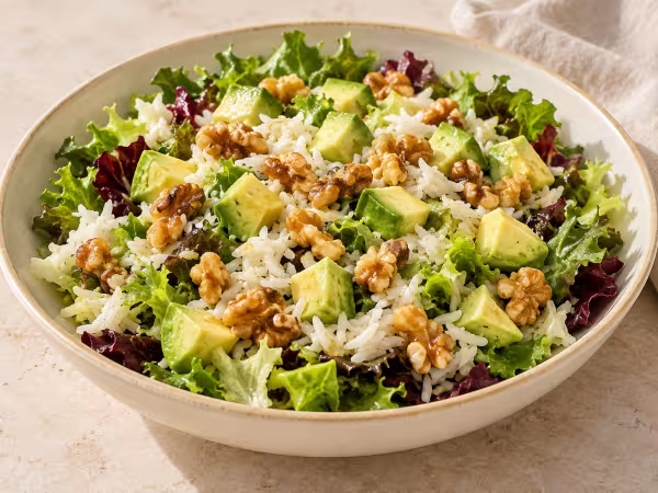 Basmati rice salad with avocado and walnuts ready to serve