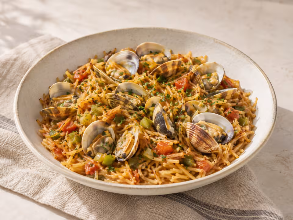 Toasted noodles with clams and spring garlic ready to serve