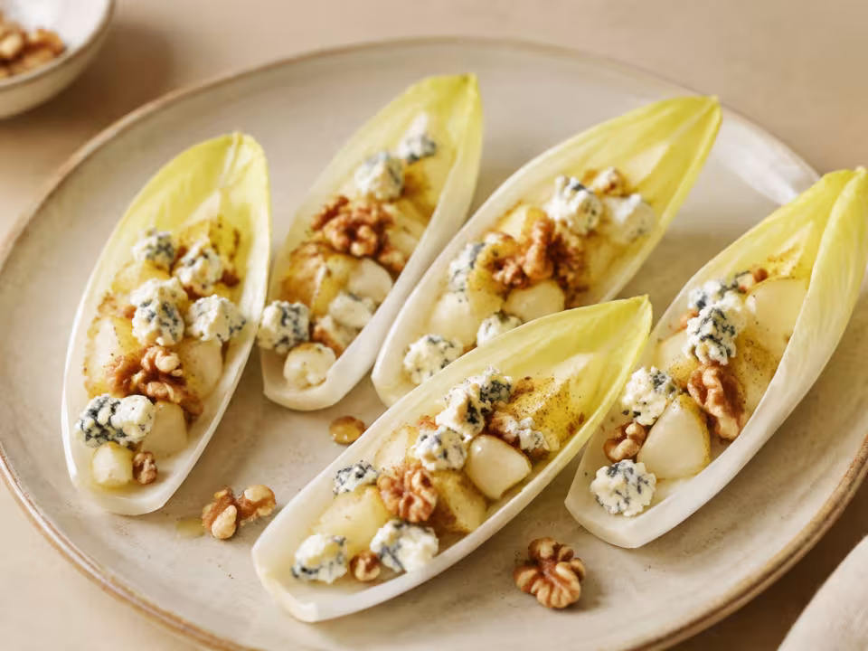 Stuffed chicory with pear, walnuts and cheese plated and ready to eat