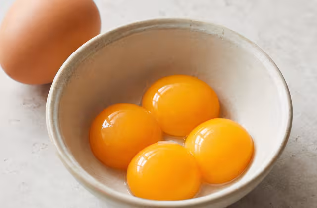 The creamy part of an egg, rich in fat and natural emulsifiers.